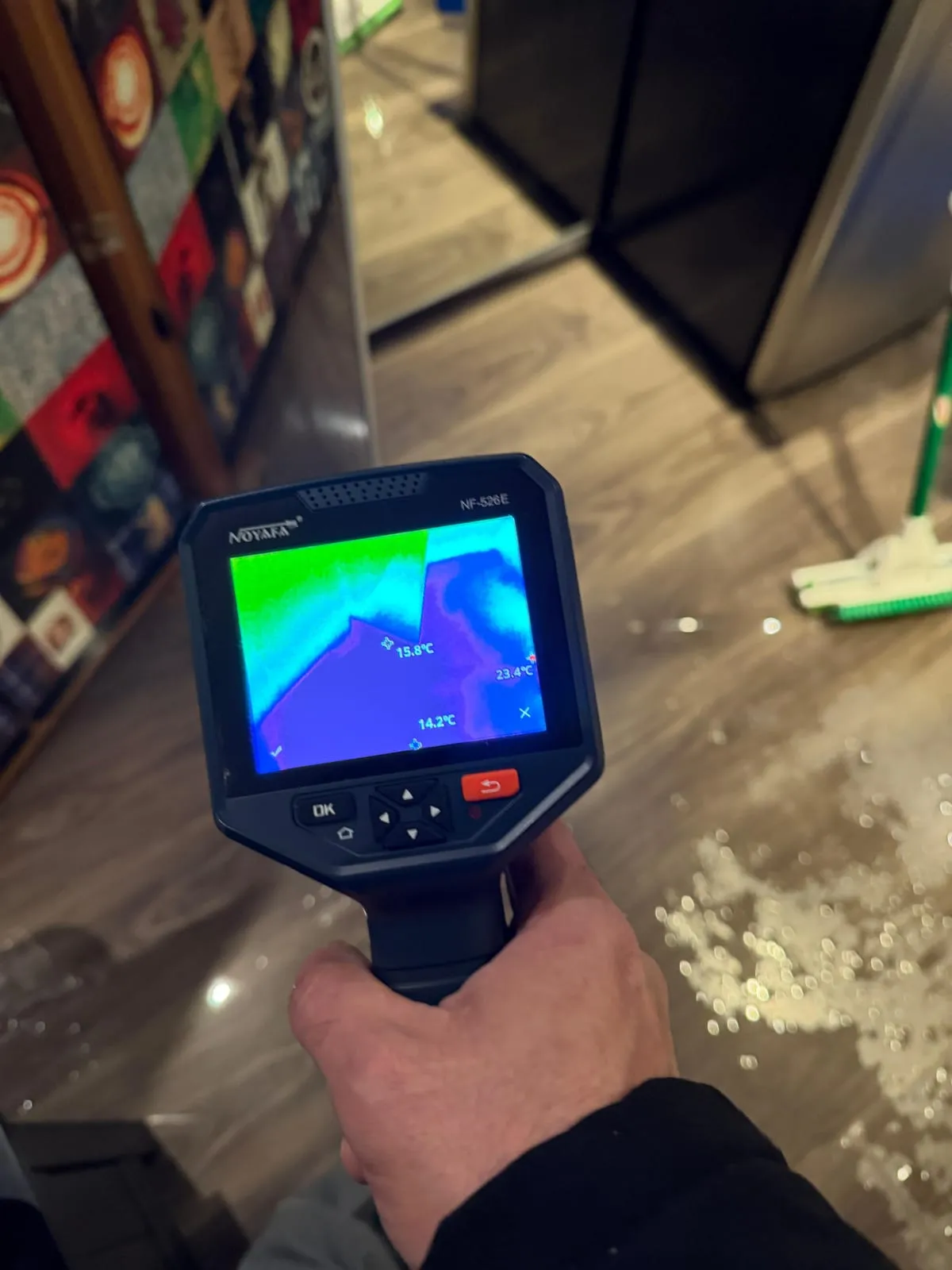 Thermal camera documenting moisture on a wet floor for an insurance claim